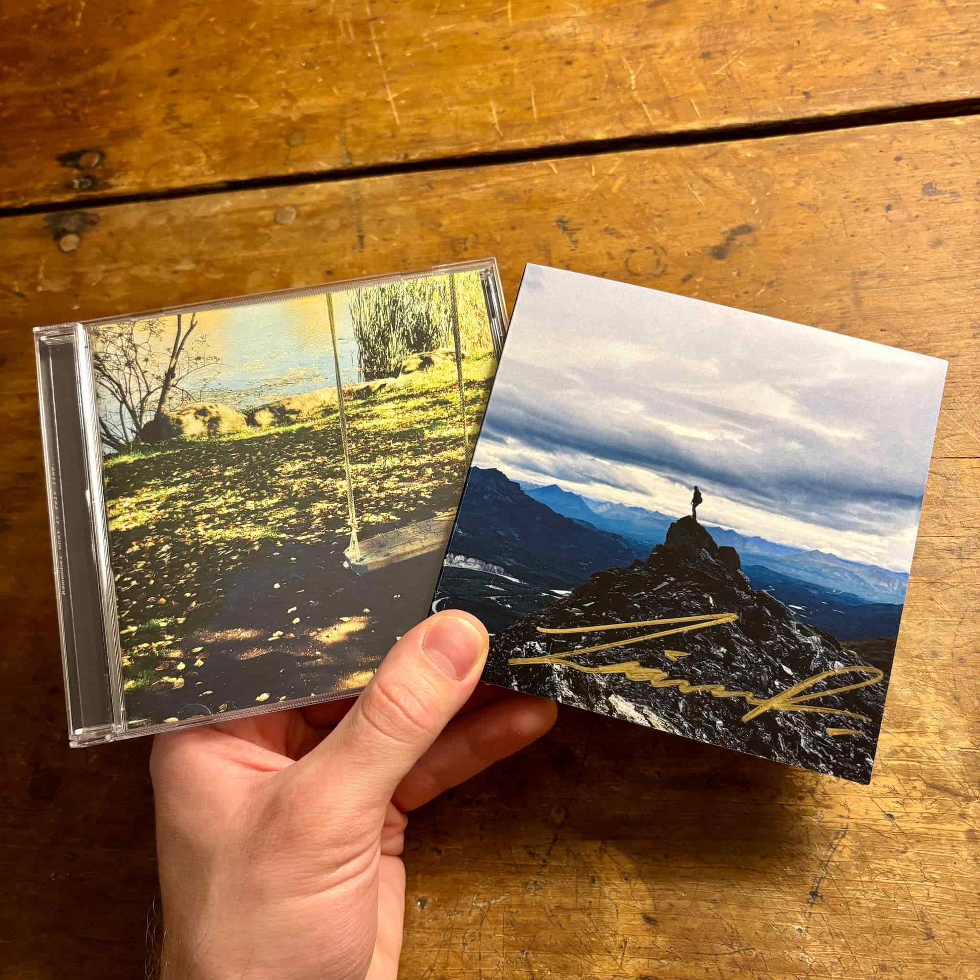 Hand holding two CDs.