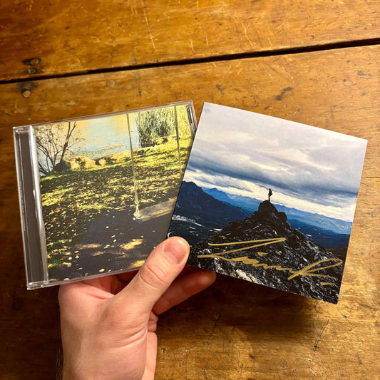 Hand holding two CDs.