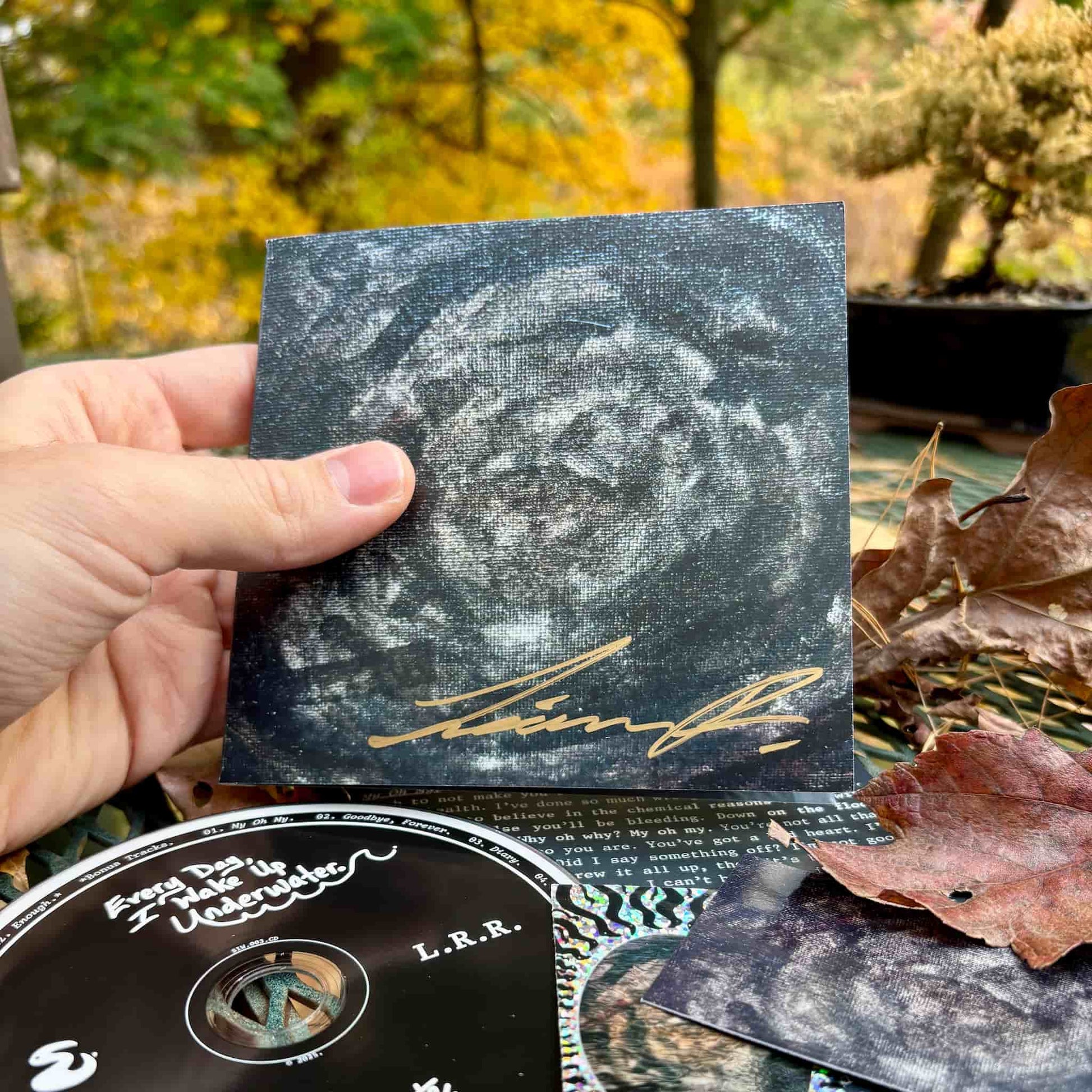 "Every Day, I Wake Up Underwater" front of CD wallet w/ autograph.