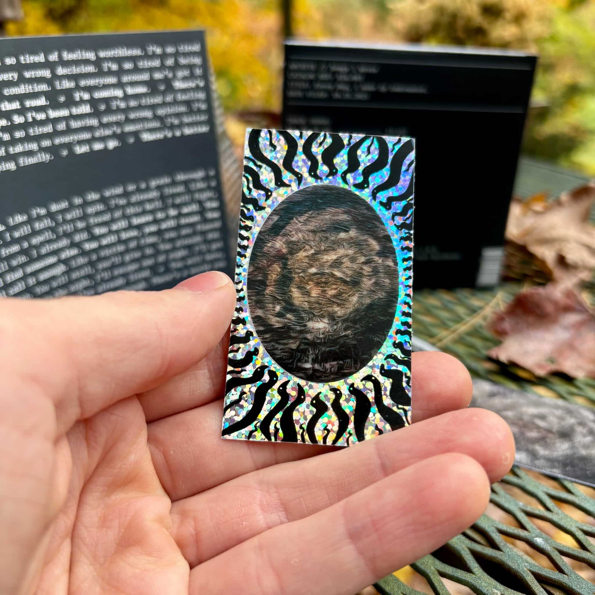 Glitter sticker w/ "Underwater" art in hand.