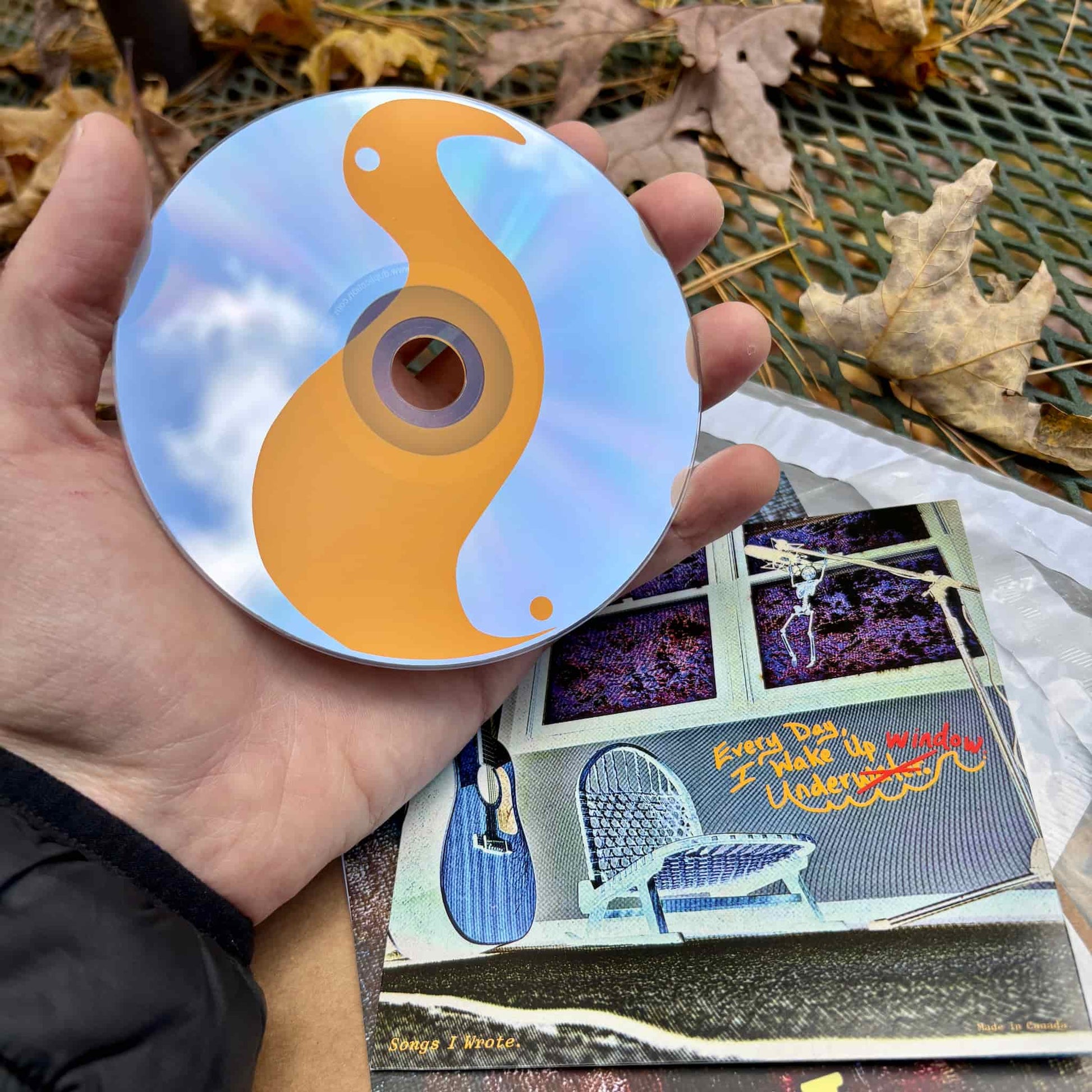 Front of disc: "Every Day, I Wake Up Underwater" CD + back of packaging.